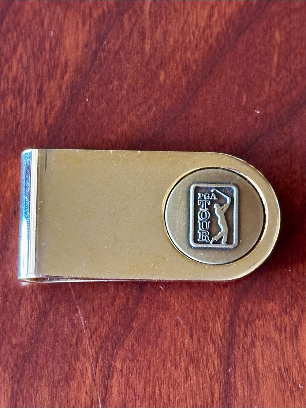 PGA Tour Money Clip Goldtone with PGA Tour Ball Marker embedded on front.